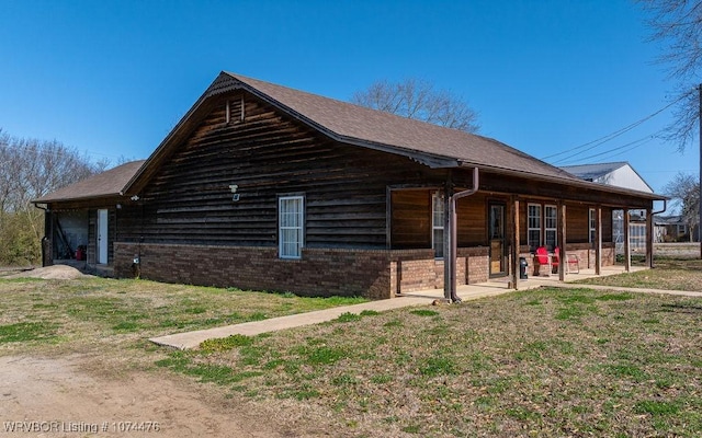 view of property exterior with a patio area and a lawn