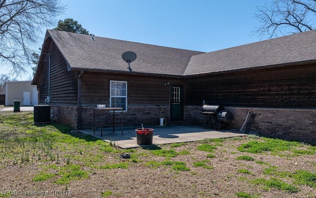 back of house with central AC unit and a patio