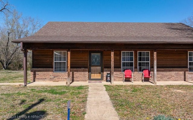 451 Hill St, Booneville, AR 72927 - view of front facade with a front lawn, a shingled roof, and brick siding