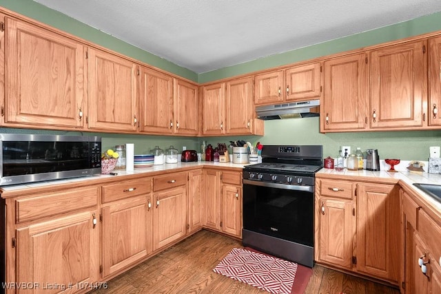 kitchen with sink, light wood-type flooring, and appliances with stainless steel finishes