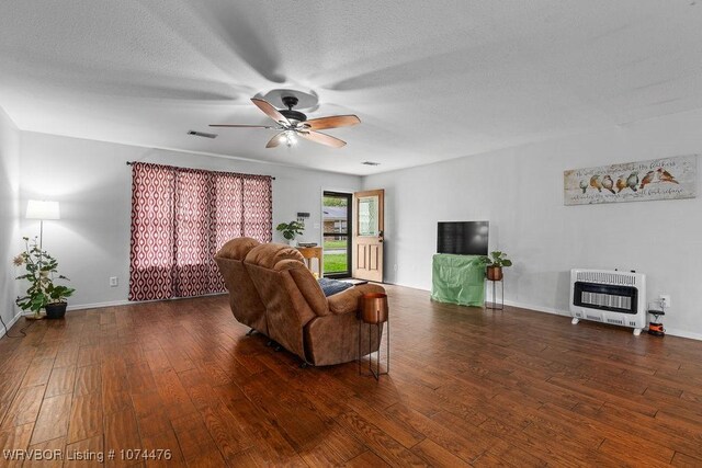 451 Hill St, Booneville, AR 72927 - living room with hardwood / wood-style floors, baseboards, heating unit, and a ceiling fan