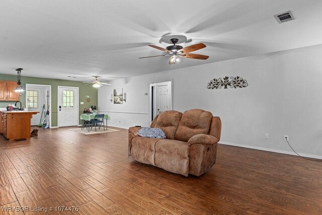 451 Hill St, Booneville, AR 72927 - living area with ceiling fan, visible vents, dark wood-style floors, and baseboards