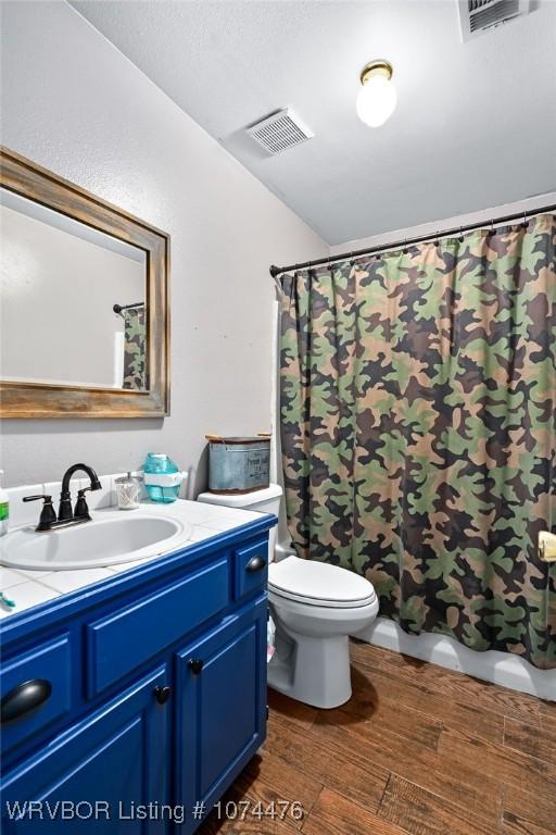 bathroom featuring hardwood / wood-style flooring, vanity, and toilet