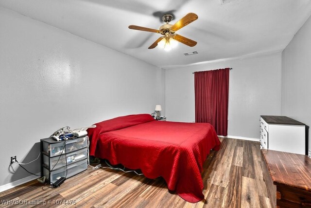 bedroom featuring ceiling fan and hardwood / wood-style flooring