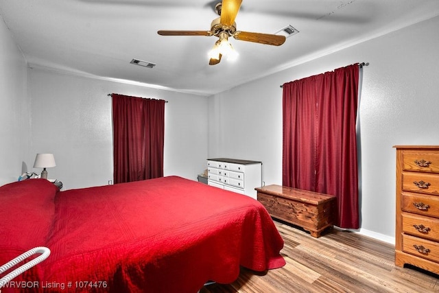 bedroom with ceiling fan and light hardwood / wood-style floors