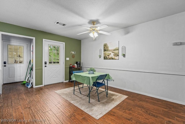 451 Hill St, Booneville, AR 72927 - dining area with visible vents, wood finished floors, ceiling fan, and a textured ceiling