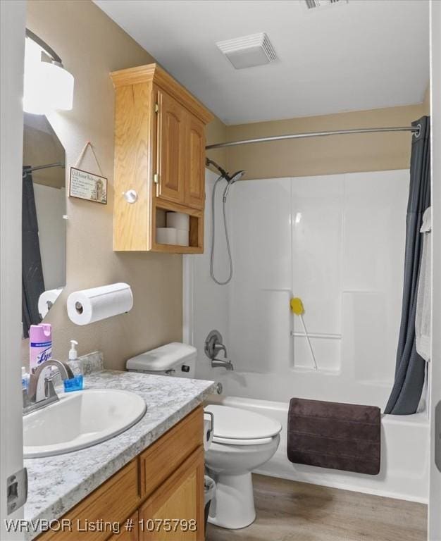 full bathroom featuring shower / bath combination with curtain, vanity, wood-type flooring, and toilet