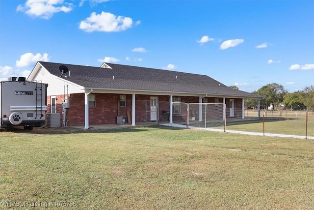 view of front facade with central AC unit and a front yard