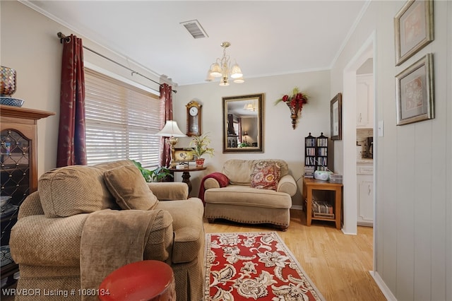3032 King Dr, Mulberry, AR 72947 - living area featuring ornamental molding, visible vents, light wood-type flooring, and an inviting chandelier