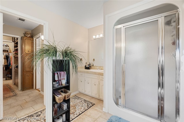 3032 King Dr, Mulberry, AR 72947 - bathroom featuring visible vents, a spacious closet, vanity, tile patterned floors, and a stall shower