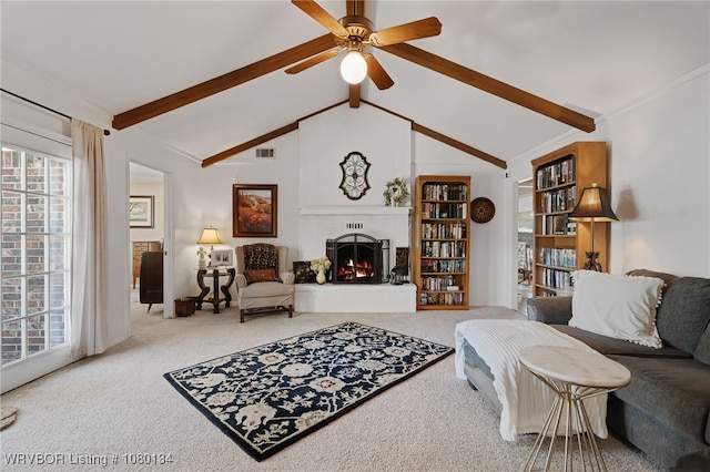 3032 King Dr, Mulberry, AR 72947 - carpeted living room featuring a warm lit fireplace, visible vents, ceiling fan, and lofted ceiling with beams