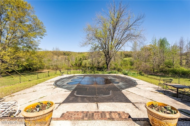 3032 King Dr, Mulberry, AR 72947 - view of pool featuring a patio area, a forest view, and fence