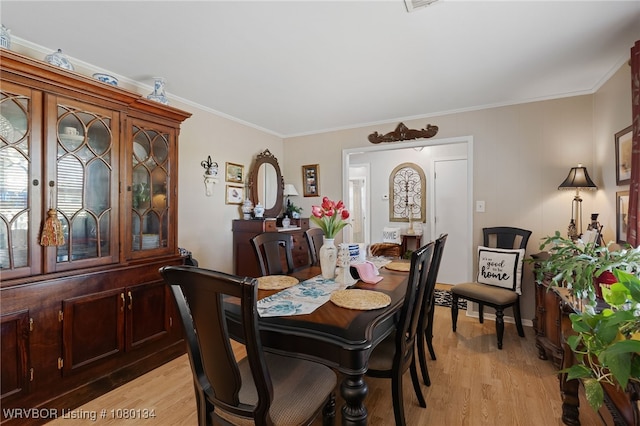3032 King Dr, Mulberry, AR 72947 - dining room with light wood-style floors and ornamental molding