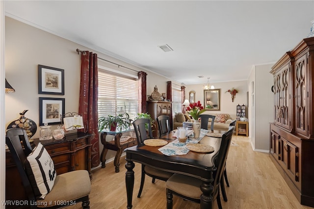 3032 King Dr, Mulberry, AR 72947 - dining space featuring crown molding, light wood-style flooring, a notable chandelier, and baseboards