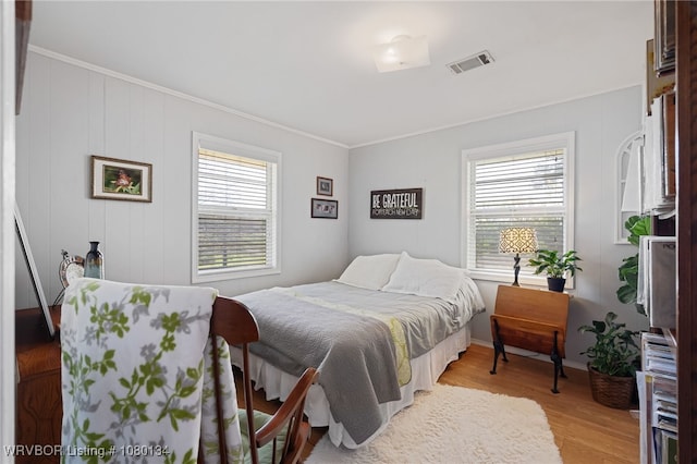 3032 King Dr, Mulberry, AR 72947 - bedroom featuring light wood-type flooring, visible vents, multiple windows, and ornamental molding