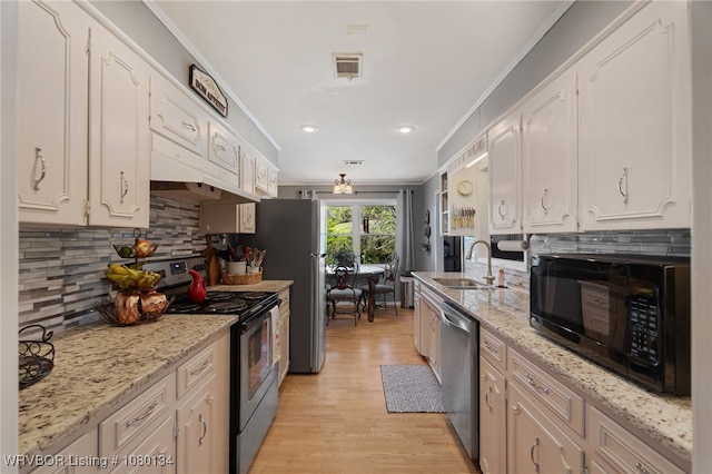 3032 King Dr, Mulberry, AR 72947 - kitchen with visible vents, a sink, crown molding, white cabinetry, and stainless steel appliances