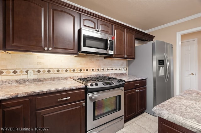 kitchen featuring appliances with stainless steel finishes, tasteful backsplash, dark brown cabinets, light tile patterned flooring, and ornamental molding