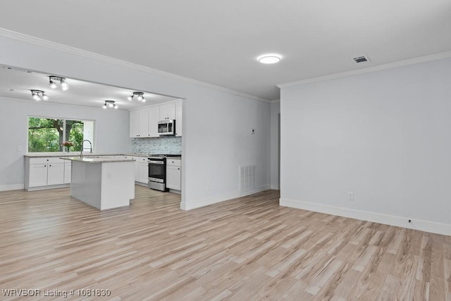 2420 Independence St, Fort Smith, AR 72901 - kitchen with appliances with stainless steel finishes, light wood-style flooring, white cabinets, ornamental molding, and a center island