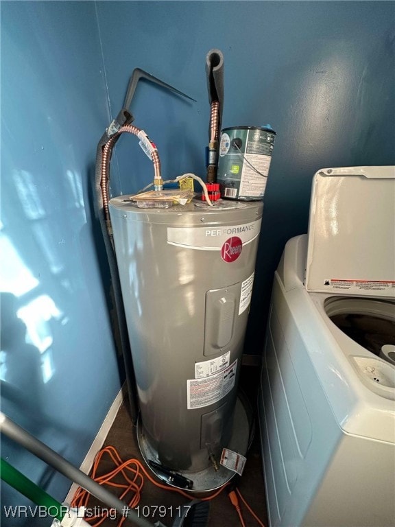 utility room with electric water heater and washer / dryer