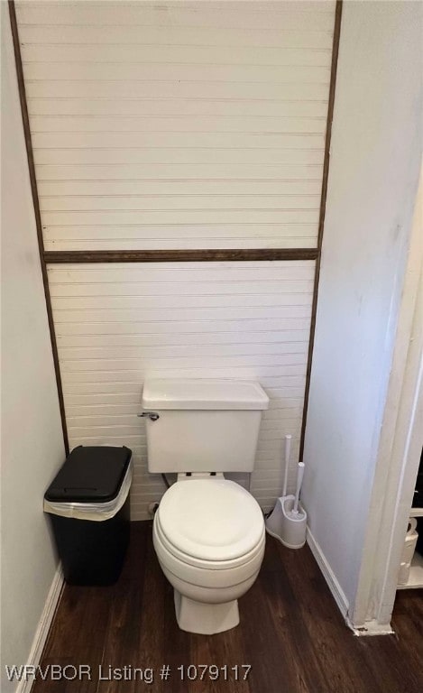 bathroom featuring baseboards, toilet, and wood finished floors