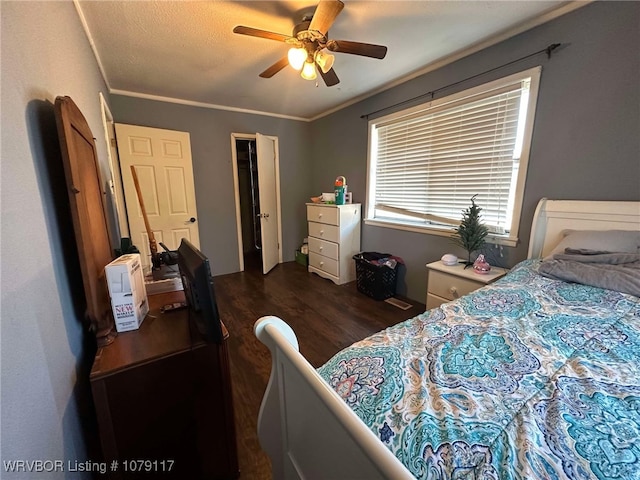 bedroom with dark wood-style floors, a ceiling fan, and crown molding