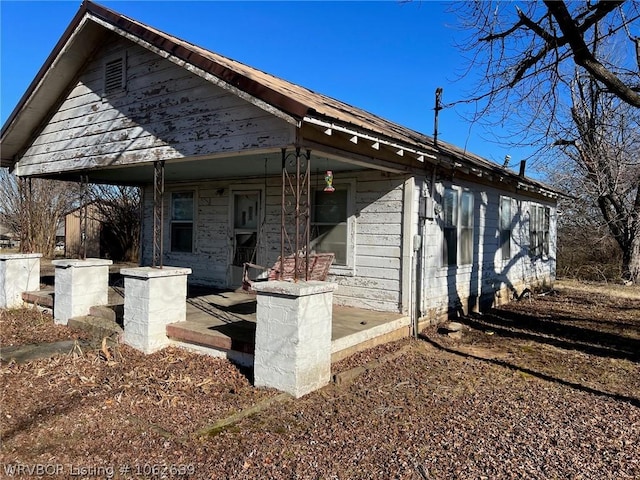 rear view of property with a porch