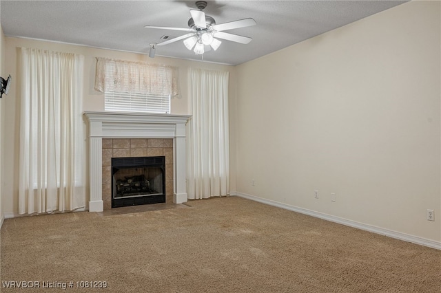 330 Northridge Dr, Van Buren, AR 72956 - unfurnished living room with a ceiling fan, a tiled fireplace, carpet flooring, baseboards, and a textured ceiling