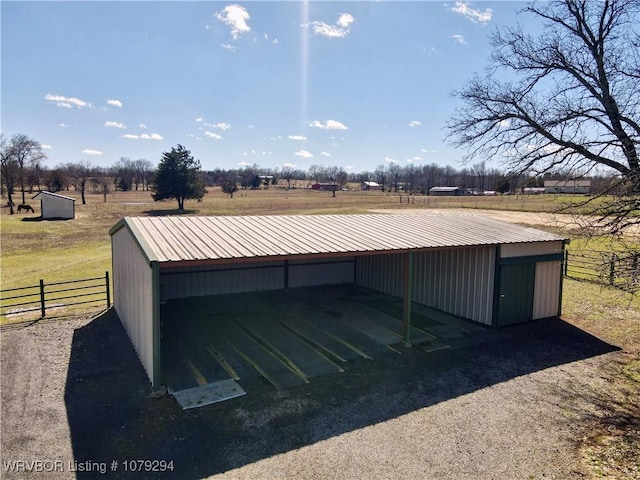 view of pole building with fence