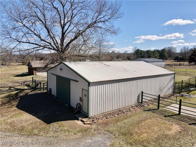 view of pole building featuring fence