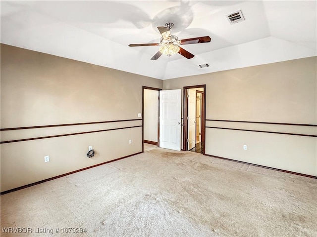 unfurnished bedroom with lofted ceiling, baseboards, visible vents, and carpet