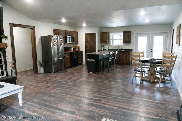 dining area featuring sink, dark hardwood / wood-style flooring, and french doors