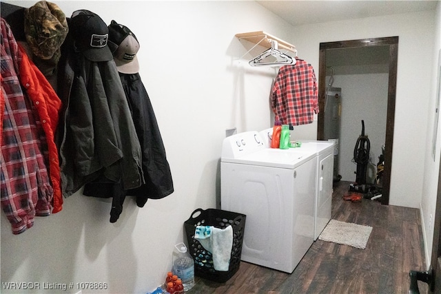 laundry area featuring electric water heater, dark wood-type flooring, and washer and dryer