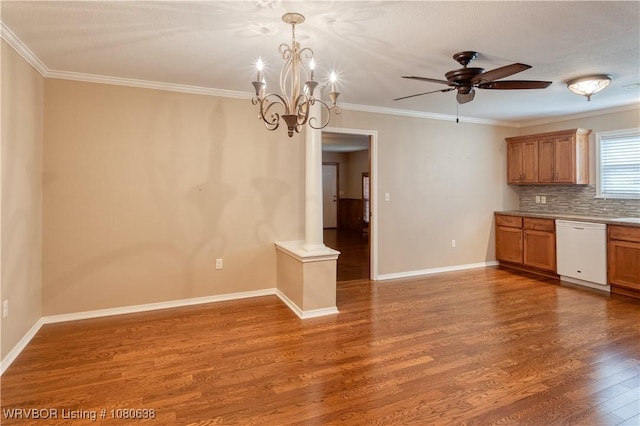 kitchen with white dishwasher, ceiling fan with notable chandelier, wood finished floors, tasteful backsplash, and ornamental molding