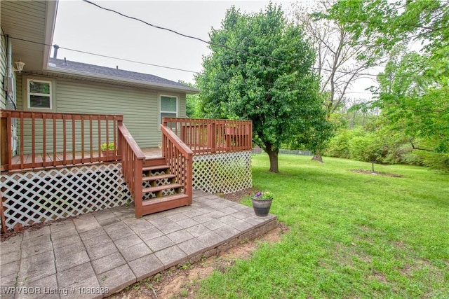 wooden deck featuring a patio and a yard