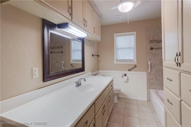 full bath featuring visible vents, vanity, a textured wall, toilet, and tile patterned floors
