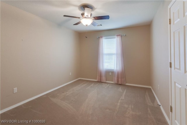 empty room with baseboards, light carpet, and a ceiling fan
