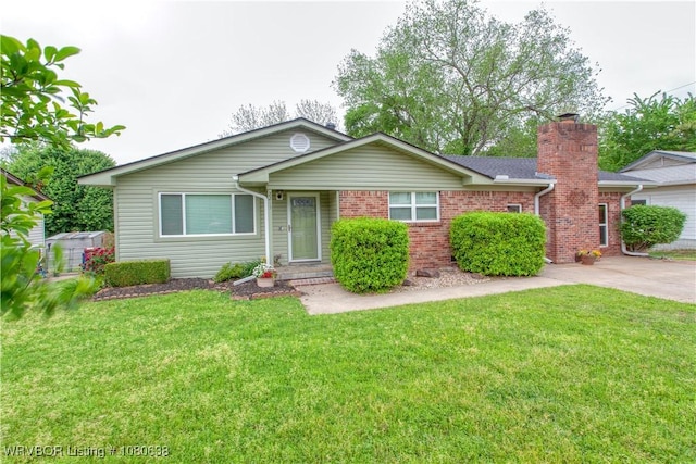 single story home with brick siding, a front lawn, and a chimney