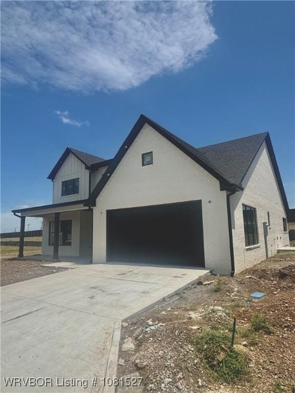 7005 Alianna Way, Fort Smith, AR 72916 - modern inspired farmhouse with concrete driveway, an attached garage, a porch, and roof with shingles