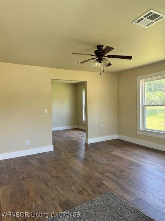 spare room with ceiling fan and dark hardwood / wood-style flooring