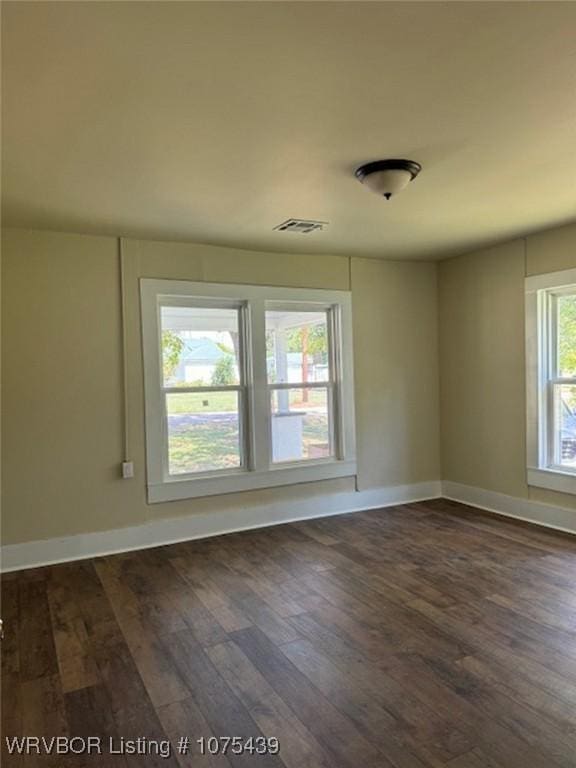 spare room featuring dark hardwood / wood-style flooring