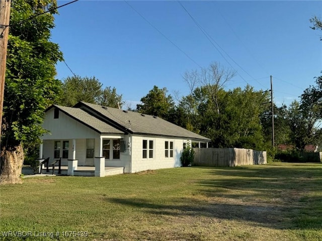 back of property featuring a lawn