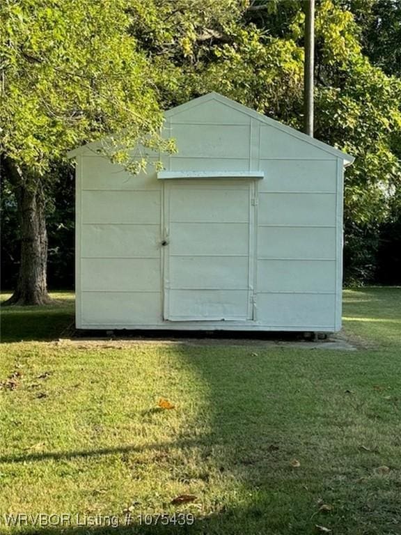 view of outdoor structure featuring a lawn