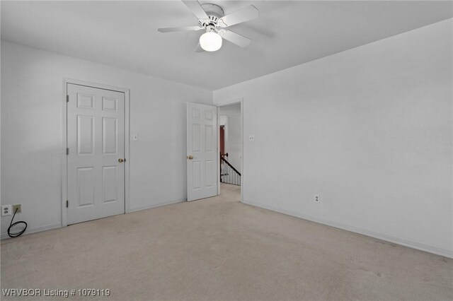 10408 Tweed Ln, Fort Smith, AR 72908 - unfurnished bedroom featuring baseboards, a ceiling fan, and light colored carpet