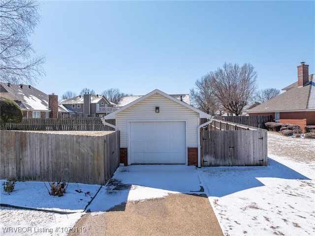 10408 Tweed Ln, Fort Smith, AR 72908 - snow covered garage featuring a residential view and fence
