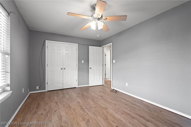 unfurnished bedroom featuring a closet, ceiling fan, and light hardwood / wood-style flooring