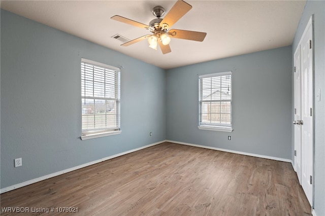 unfurnished bedroom with multiple windows, light hardwood / wood-style floors, and ceiling fan