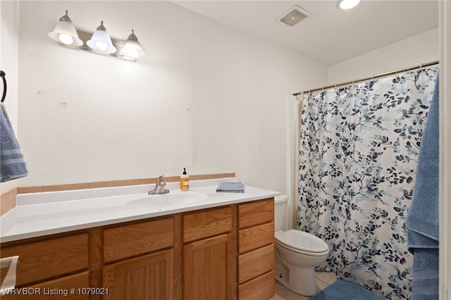 bathroom featuring vanity, tile patterned floors, toilet, and a shower with shower curtain