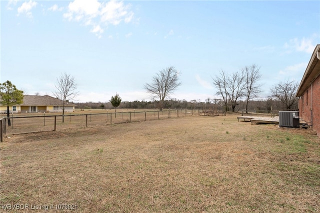 view of yard featuring a rural view and central AC unit