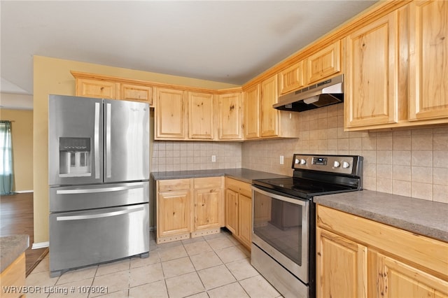 kitchen with stainless steel appliances, light tile patterned flooring, tasteful backsplash, and light brown cabinetry