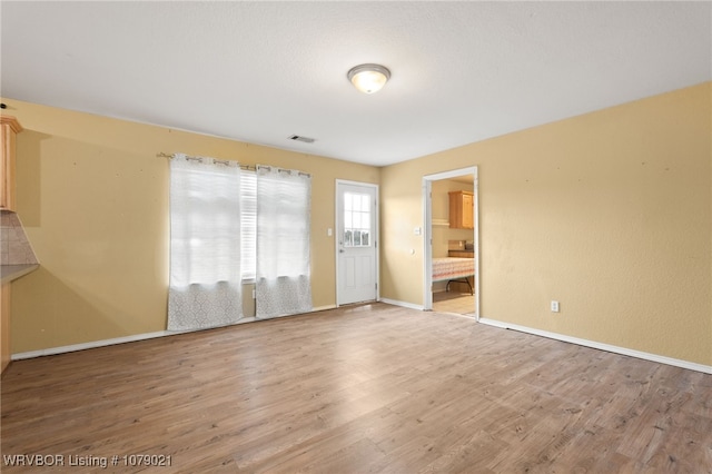 unfurnished room with wood-type flooring